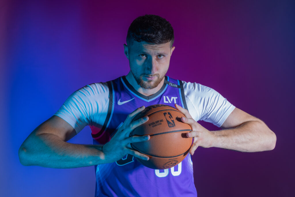 Jusuf Nurkic portrait during Utah Jazz NBA Media Day holding a basketball under colored studio lighting.