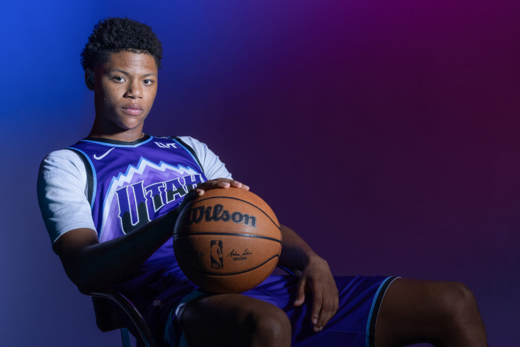 Ace Bailey portrait during Utah Jazz NBA Media Day holding a basketball under colored studio lighting.
