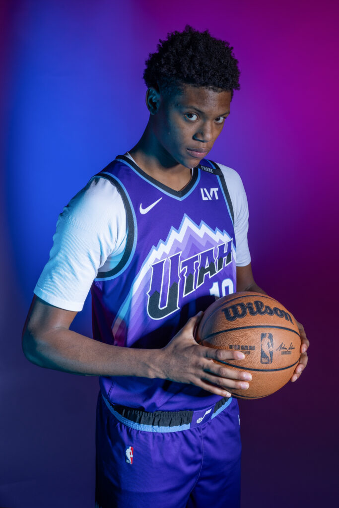 Ace Bailey portrait during Utah Jazz NBA Media Day holding a basketball under colored studio lighting.
