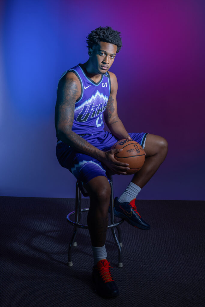 Brice Sensabaugh portrait during Utah Jazz NBA Media Day holding a basketball under colored studio lighting.