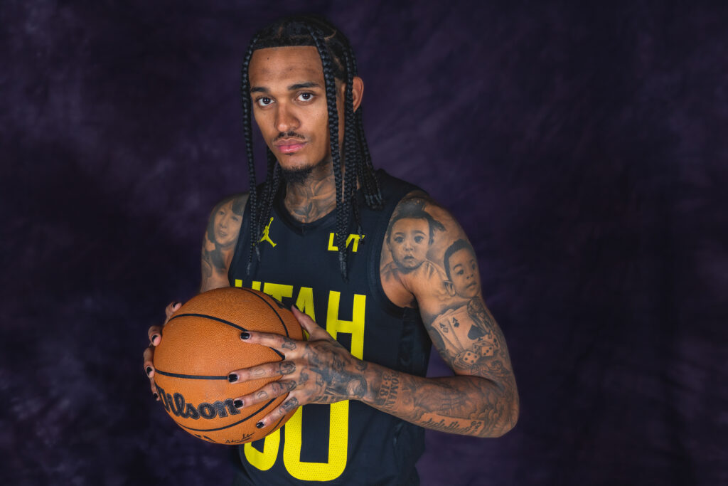 Jordan Clarkson portrait during Utah Jazz NBA Media Day holding a basketball under colored studio lighting.