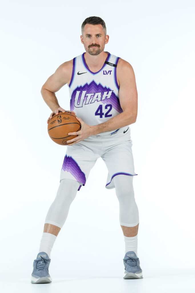 Kevin Love portrait during Utah Jazz NBA Media Day holding a basketball under colored studio lighting.