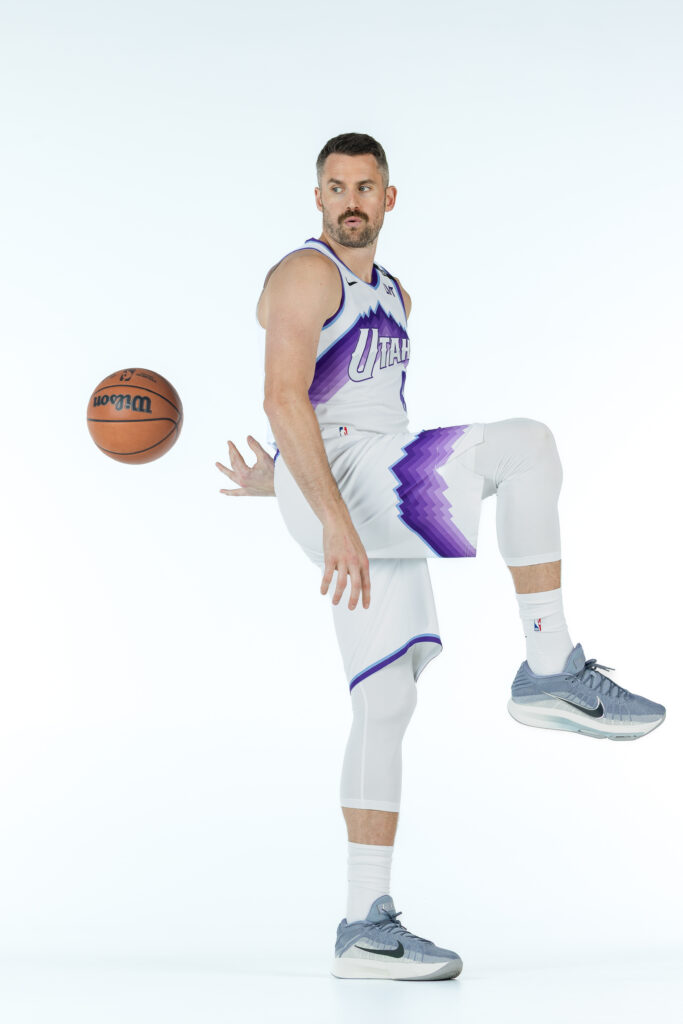 Kevin Love portrait during Utah Jazz NBA Media Day holding a basketball under colored studio lighting.