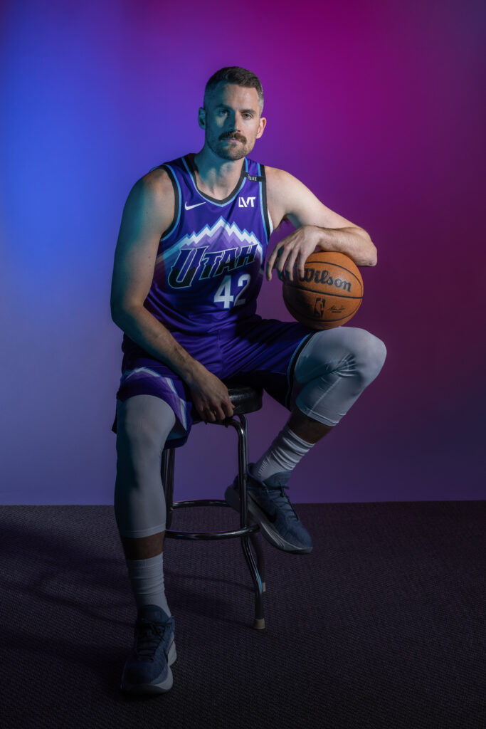 Kevin Love portrait during Utah Jazz NBA Media Day holding a basketball under colored studio lighting.