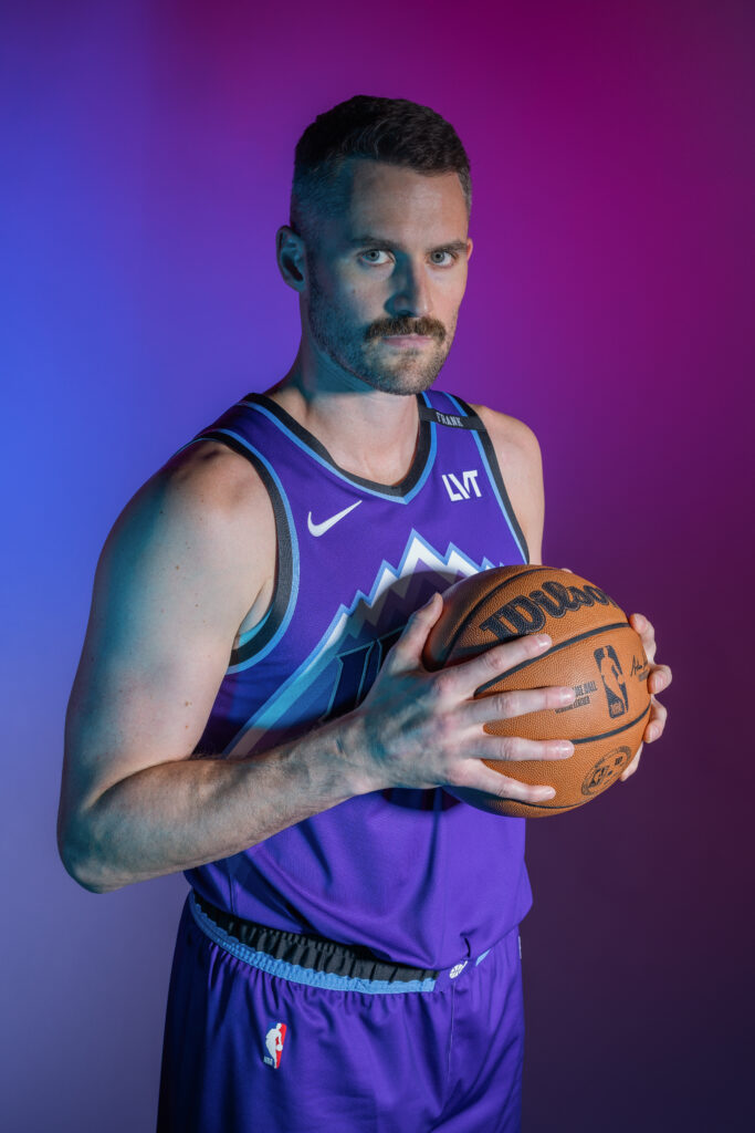 Kevin Love portrait during Utah Jazz NBA Media Day holding a basketball under colored studio lighting.