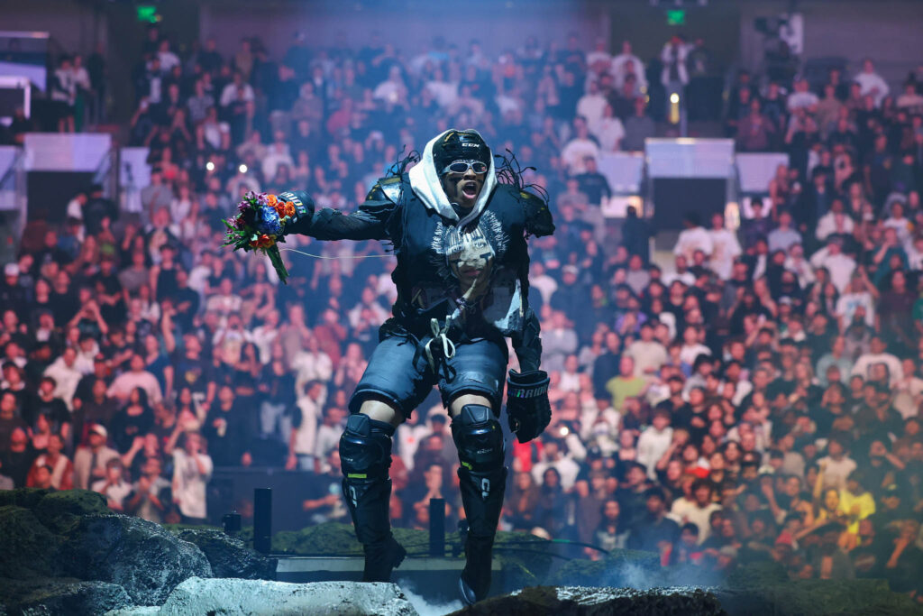 Travis Scott performing live in concert during a high-energy hip hop stage performance