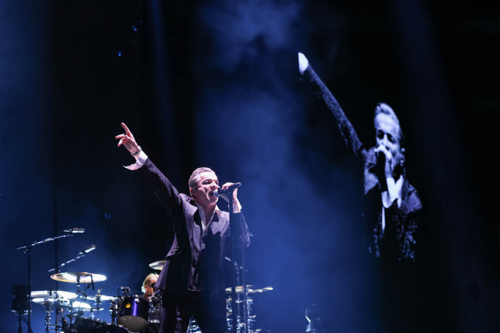 Depeche Mode performing live in concert during an electronic music stage performance
