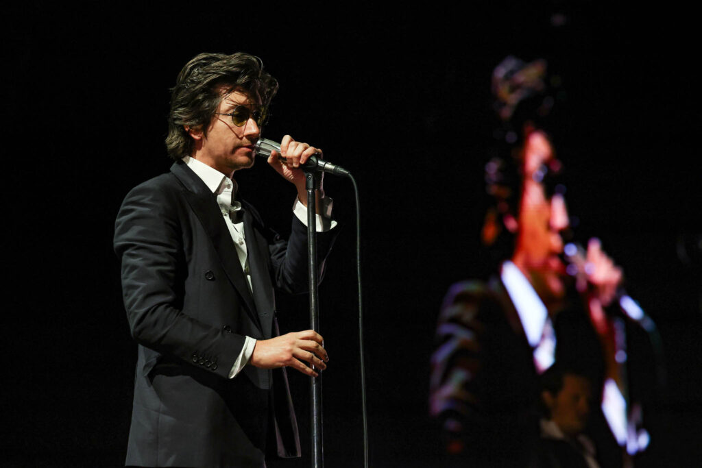 Arctic Monkeys performing live in concert during an indie rock stage performance
