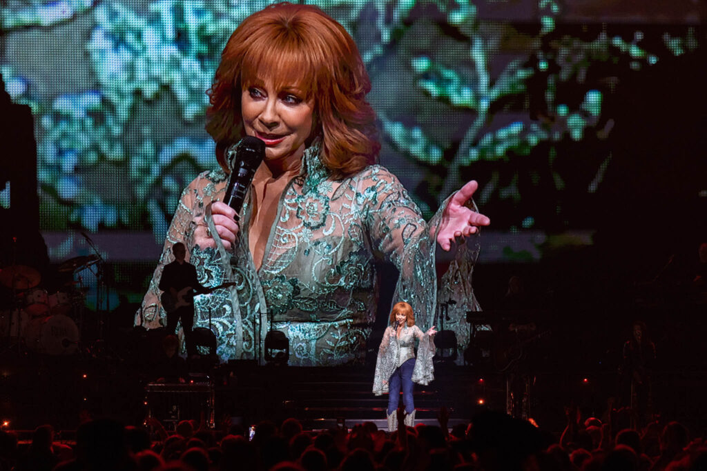 Reba McEntire performing live in concert during a country music stage performance