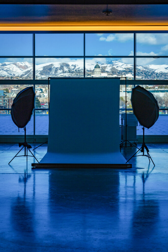 On-location portrait photography setup with lighting and backdrop overlooking the Utah State Capitol and mountains in Salt Lake City.