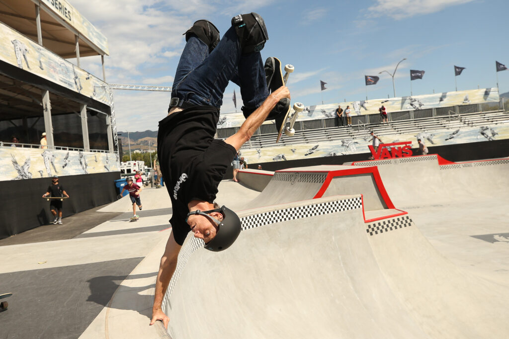 Tony Hawk performs a handplant during the opening celebration of the Vans skatepark in Salt Lake City.